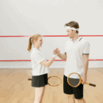 A group of young squash players in action on the court, with intense focus and swift movements