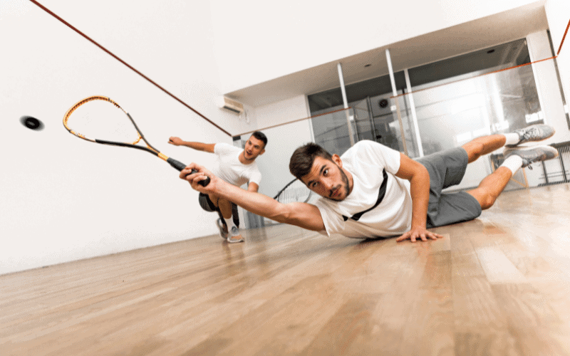 Players practicing squash, following rules to avoid injuries