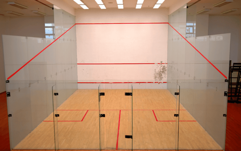 A squash court with basic equipment, focused on injury prevention